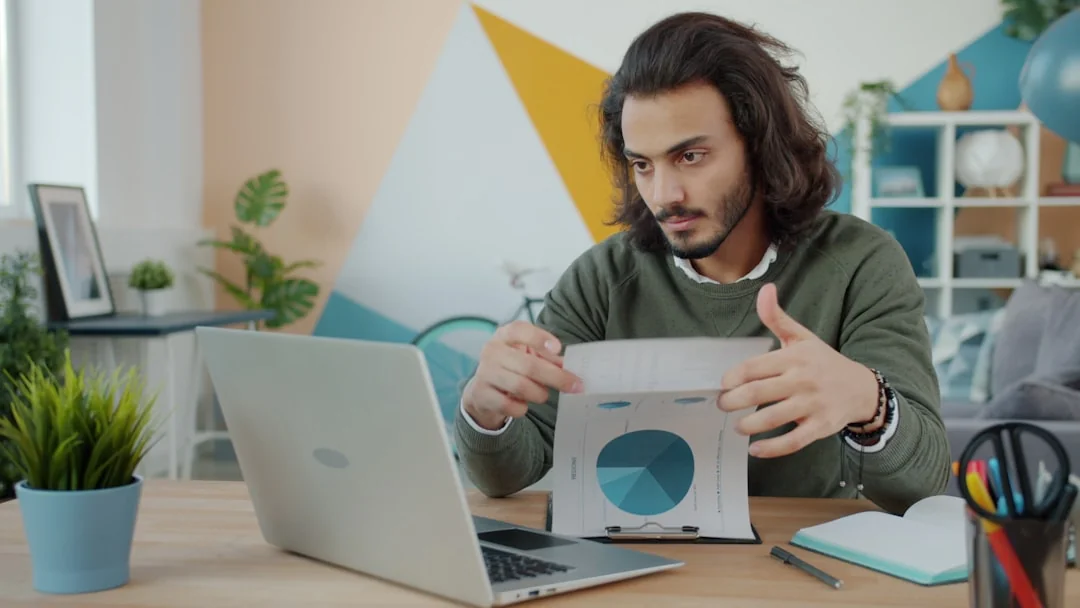 Vue de dessus d’une équipe diverse analysant des stratégies marketing à l’aide de graphiques et de schémas.
